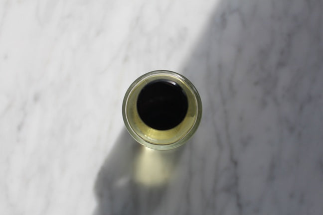 Raspberry Rouge Eau De Parfum 50ML bottle arial shot of bottle top on marble.