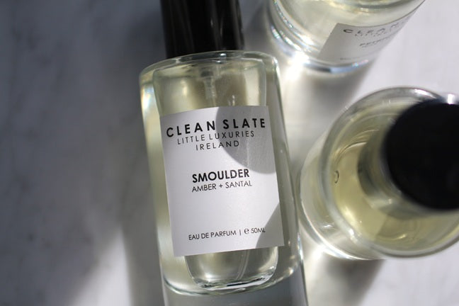 Close-up of Smoulder Eau De Parfum 50ML bottle with other bottles.